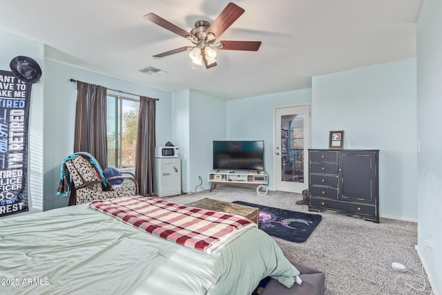 carpeted bedroom with visible vents and a ceiling fan