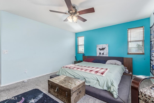 bedroom featuring baseboards, multiple windows, carpet floors, and ceiling fan