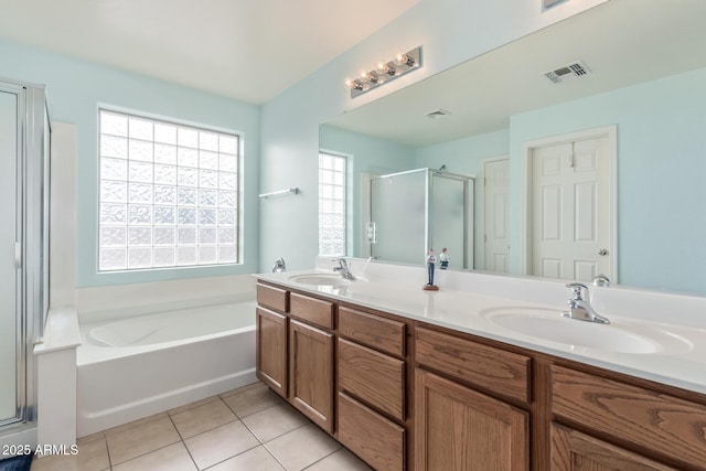 full bathroom with tile patterned flooring, visible vents, a shower stall, a garden tub, and a sink