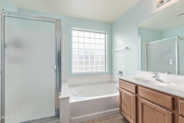 full bath featuring vanity, a shower stall, a garden tub, and tile patterned floors