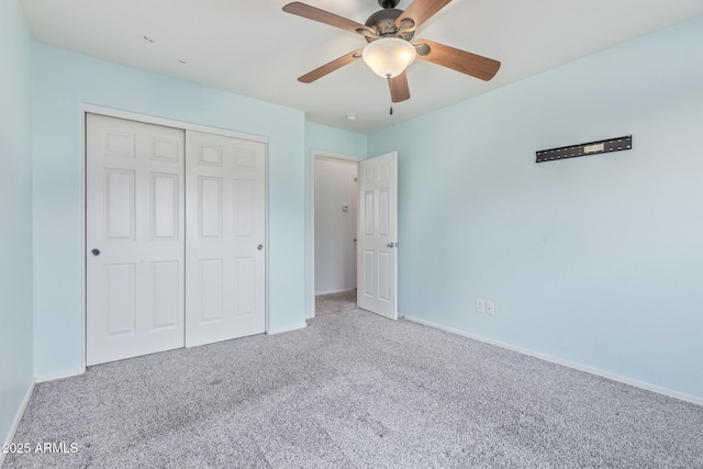 unfurnished bedroom featuring a closet, baseboards, carpet, and a ceiling fan