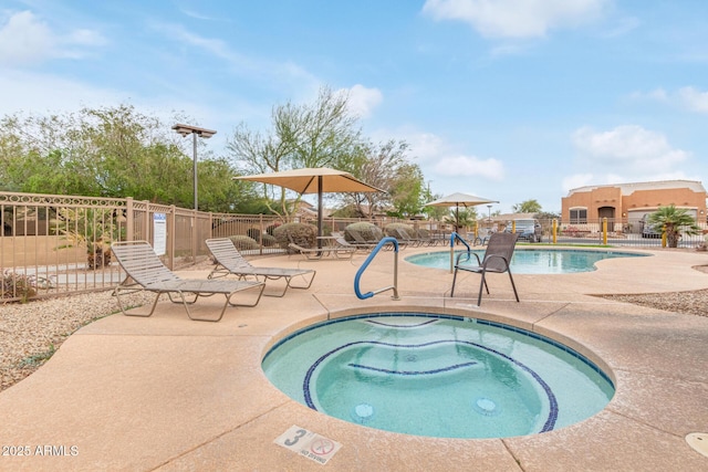 community pool featuring a patio area, fence, and a hot tub