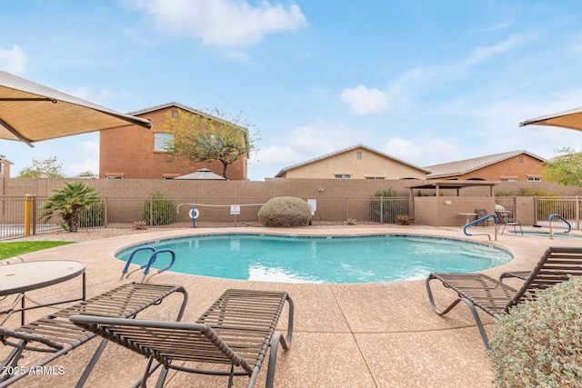 pool with a patio and a fenced backyard