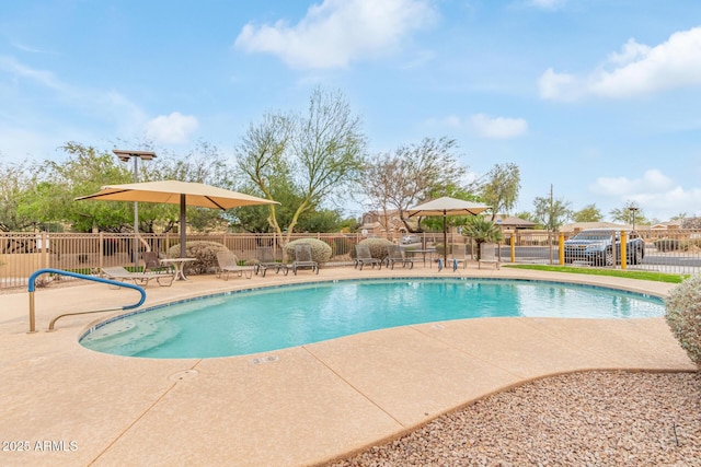 community pool featuring a patio area and fence