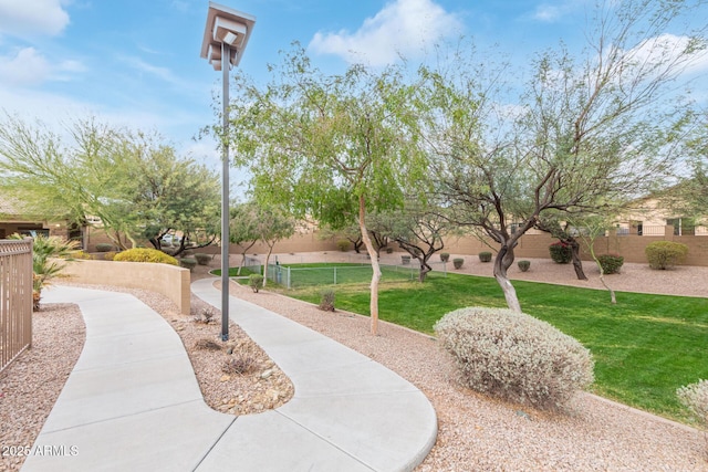 surrounding community with a yard and fence