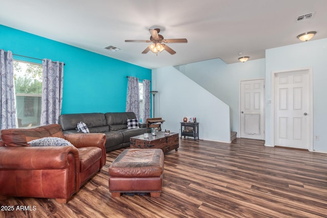 living room featuring visible vents, wood finished floors, and a ceiling fan