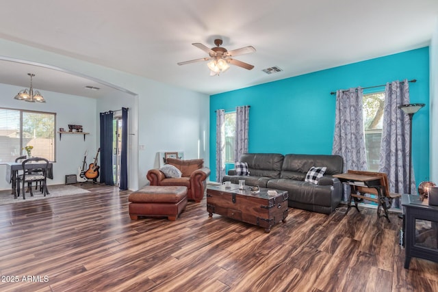 living area with visible vents, plenty of natural light, and wood finished floors