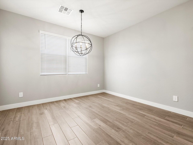17809 W Elm St, Goodyear, AZ 85395 - unfurnished room with wood finished floors, a chandelier, and baseboards