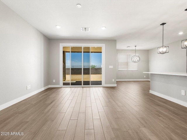 17809 W Elm St, Goodyear, AZ 85395 - empty room featuring wood finished floors, plenty of natural light, baseboards, and recessed lighting