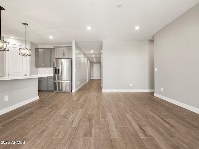 17809 W Elm St, Goodyear, AZ 85395 - unfurnished living room with wood finished floors, baseboards, a chandelier, and recessed lighting