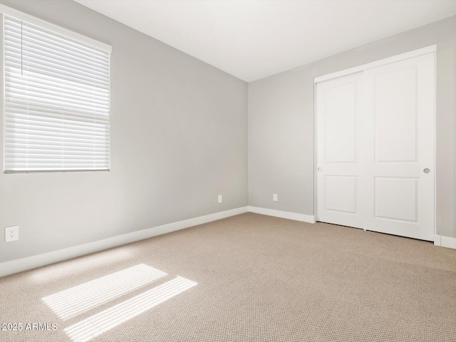 17809 W Elm St, Goodyear, AZ 85395 - unfurnished bedroom with carpet flooring, baseboards, and a closet