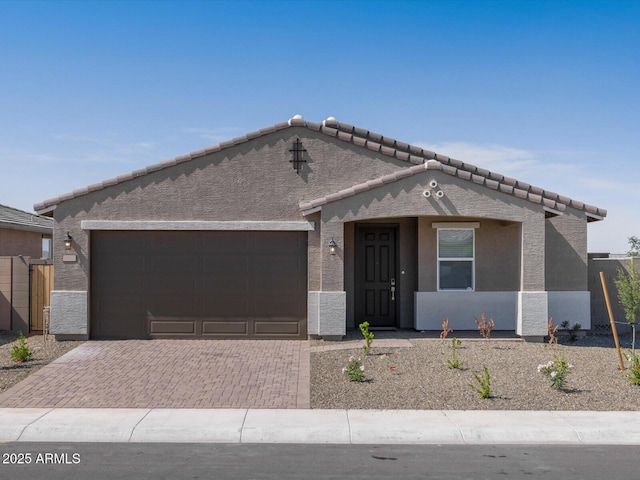 17809 W Elm St, Goodyear, AZ 85395 - view of front facade with an attached garage, a tile roof, and stucco siding