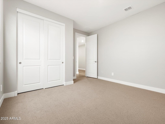 17809 W Elm St, Goodyear, AZ 85395 - unfurnished bedroom featuring light colored carpet, baseboards, and a closet