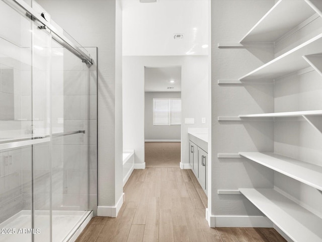17809 W Elm St, Goodyear, AZ 85395 - full bath featuring a stall shower, baseboards, and wood finished floors