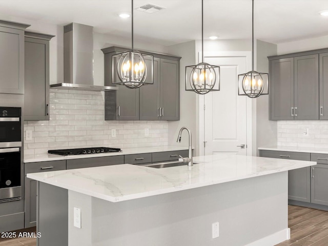 17809 W Elm St, Goodyear, AZ 85395 - kitchen featuring gray cabinetry, a chandelier, wall chimney range hood, gas stovetop, and recessed lighting