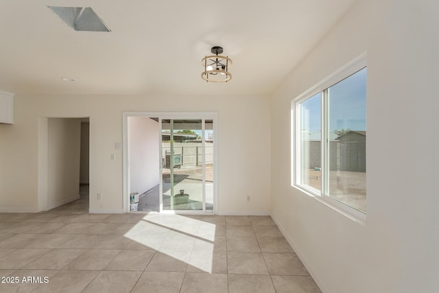 unfurnished dining area featuring light tile patterned flooring and a chandelier