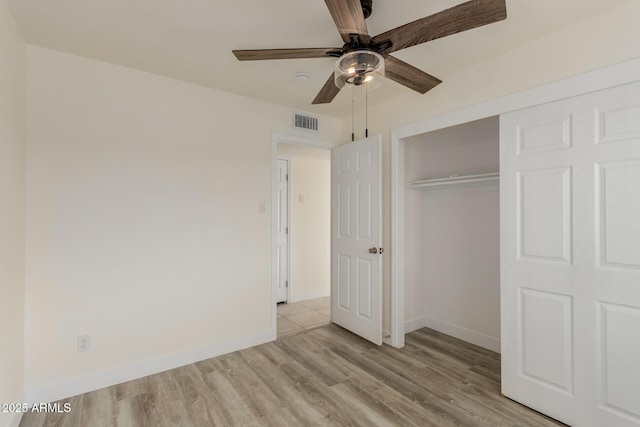 unfurnished bedroom with a closet, ceiling fan, and light hardwood / wood-style flooring