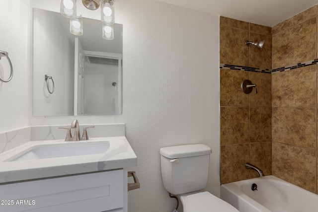 full bathroom featuring tiled shower / bath combo, vanity, and toilet