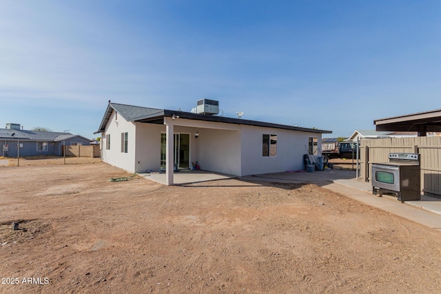 back of house with central AC unit and a patio