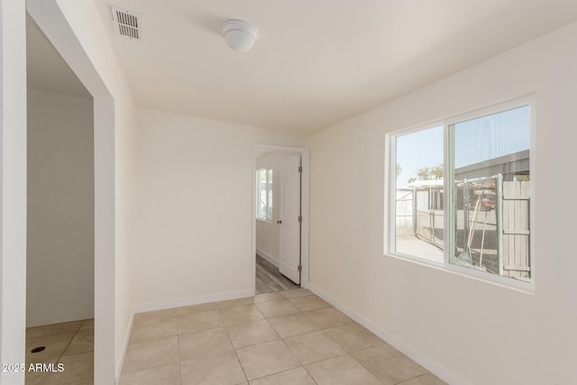 corridor featuring light tile patterned flooring