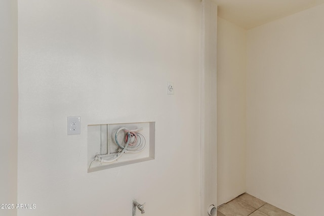 laundry area with light tile patterned floors and hookup for an electric dryer