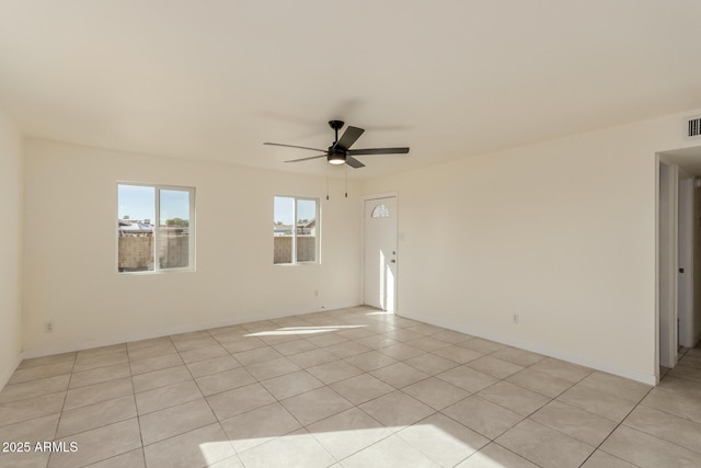 unfurnished room with light tile patterned floors and ceiling fan