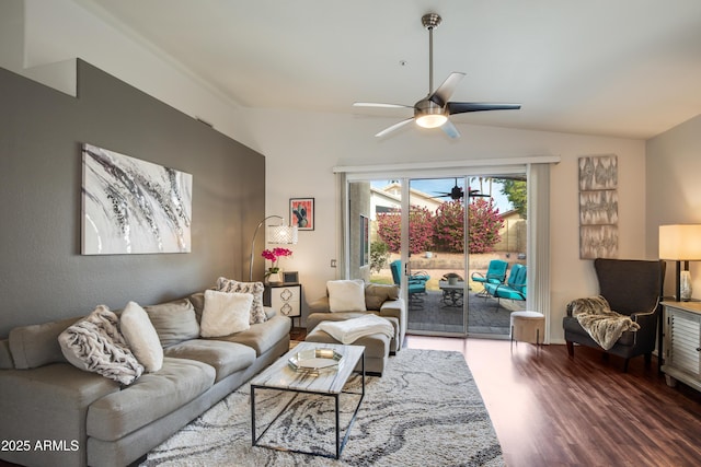 living room with ceiling fan, lofted ceiling, and dark wood-type flooring