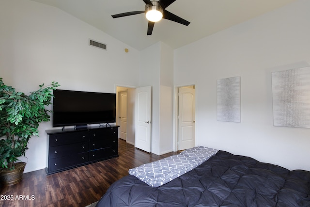 bedroom featuring dark hardwood / wood-style flooring, high vaulted ceiling, and ceiling fan