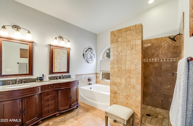 bathroom featuring vanity, tile walls, and independent shower and bath