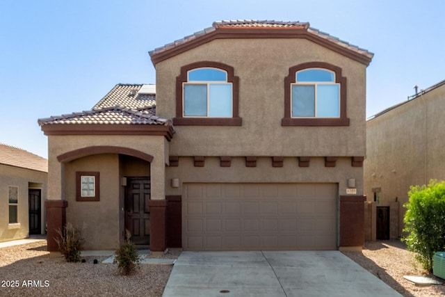 mediterranean / spanish-style house featuring concrete driveway, a tile roof, and stucco siding