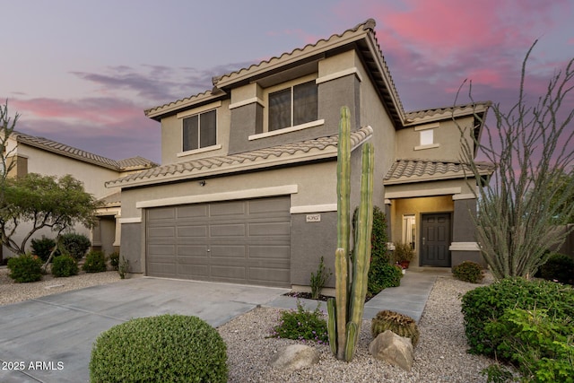 40807 N Barnum Way, Anthem, AZ 85086 - view of front of house with concrete driveway, a tiled roof, an attached garage, and stucco siding