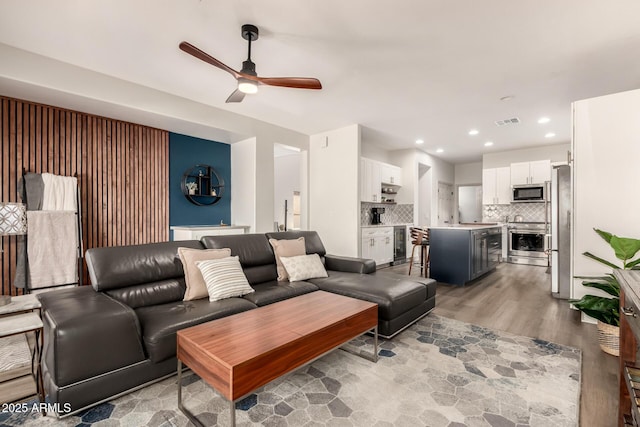 40807 N Barnum Way, Anthem, AZ 85086 - living area featuring light wood finished floors, ceiling fan, recessed lighting, and wine cooler