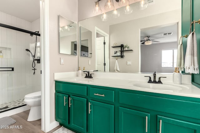 40807 N Barnum Way, Anthem, AZ 85086 - bathroom featuring ceiling fan, toilet, a stall shower, and double vanity