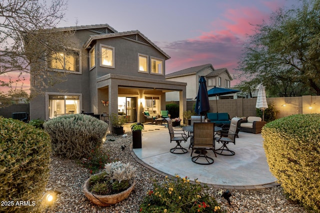 40807 N Barnum Way, Anthem, AZ 85086 - rear view of house with stucco siding, a patio area, and an outdoor hangout area