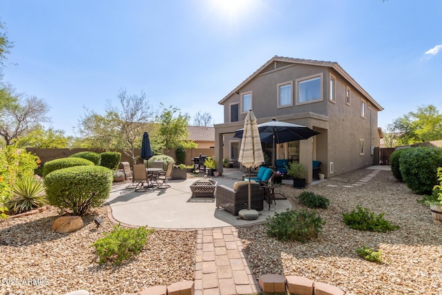 40807 N Barnum Way, Anthem, AZ 85086 - back of house with stucco siding, a patio area, an outdoor fire pit, and a fenced backyard