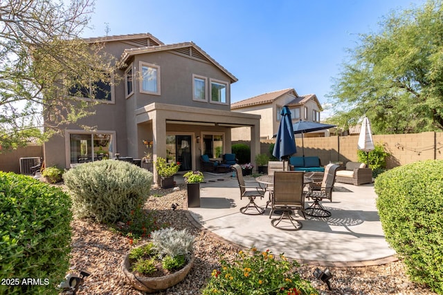 40807 N Barnum Way, Anthem, AZ 85086 - rear view of house with stucco siding, a patio area, central AC, and outdoor lounge area
