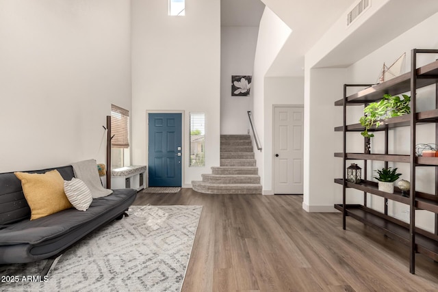 40807 N Barnum Way, Anthem, AZ 85086 - entryway with stairs, wood finished floors, baseboards, and a towering ceiling