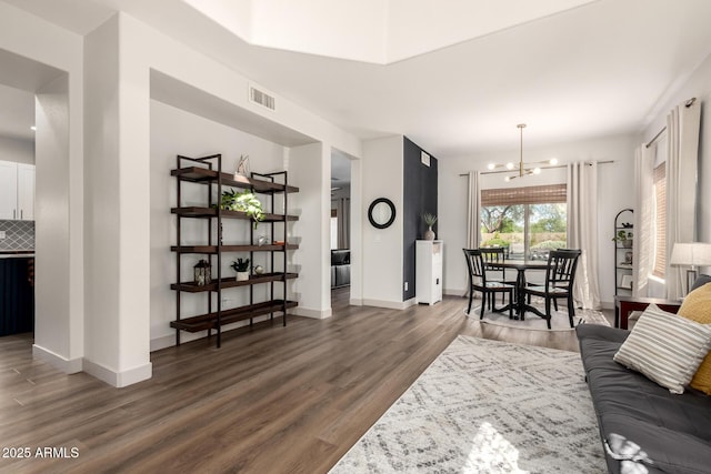 40807 N Barnum Way, Anthem, AZ 85086 - living room featuring a chandelier, wood finished floors, and baseboards