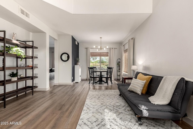 40807 N Barnum Way, Anthem, AZ 85086 - living area featuring a chandelier, wood finished floors, and baseboards