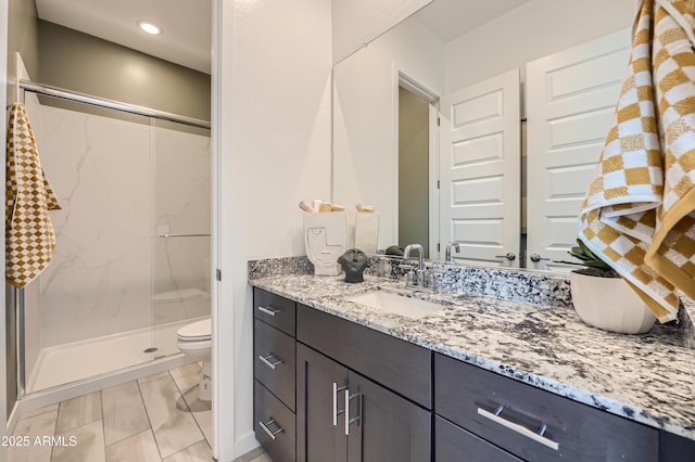 bathroom featuring a stall shower, toilet, vanity, and recessed lighting