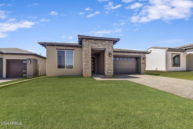 prairie-style home with a garage and a front lawn