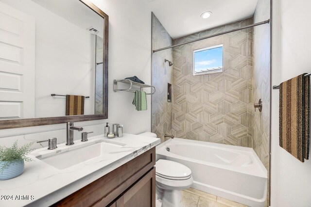 full bathroom with tile patterned flooring, vanity, toilet, and tiled shower / bath