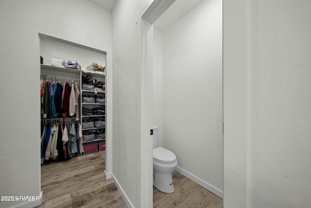 bathroom featuring hardwood / wood-style floors and toilet