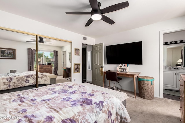 carpeted bedroom with visible vents, ceiling fan, a closet, and connected bathroom