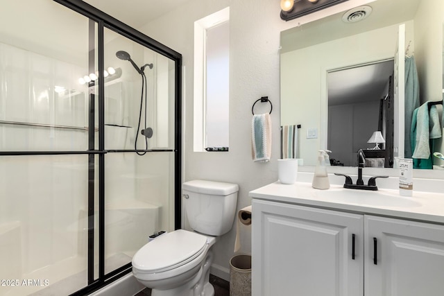 full bathroom with toilet, vanity, visible vents, and a stall shower