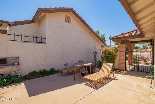 view of patio / terrace featuring fence and a gate