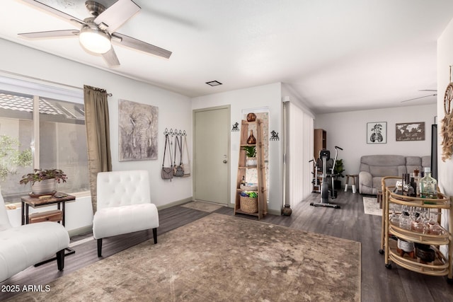 sitting room featuring ceiling fan, wood finished floors, and baseboards