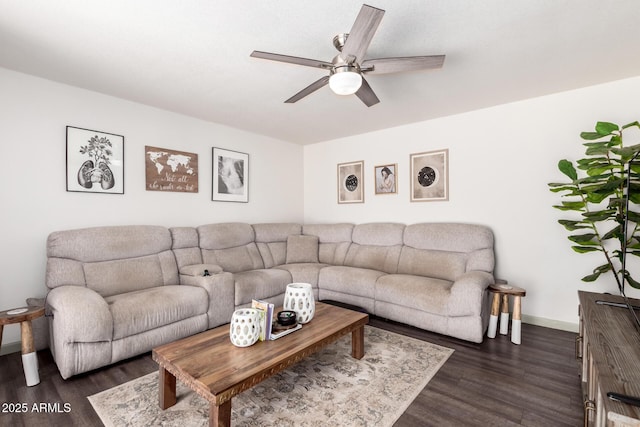 living room featuring baseboards, a ceiling fan, and dark wood-style floors