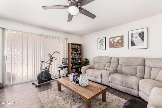 living area with wood finished floors and a ceiling fan