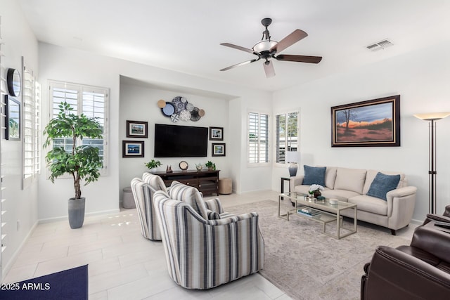 tiled living room with ceiling fan